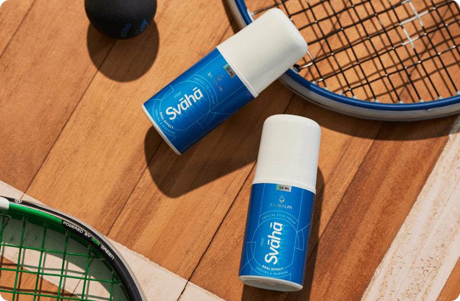 A bottle of Svaha Topical Pain Cream displaying with the backdrop of tennis racquets